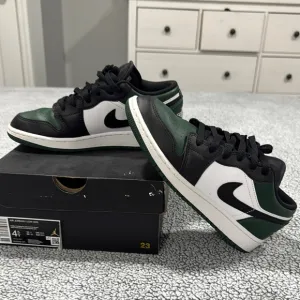 Air Jordan Low Sneakers in Black, White, and Green
