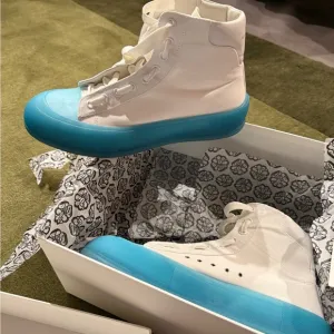 Alexander McQueen clean!!!! White Sneakers with sky Blue Soles worn once.