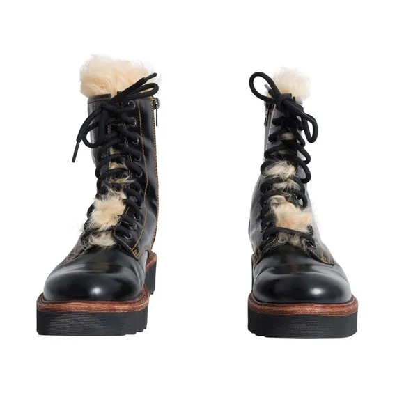Coach woman’s black Moto Hiker boot with cream colored Shearling boots