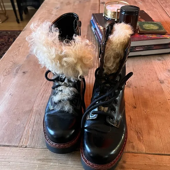 Coach woman’s black Moto Hiker boot with cream colored Shearling boots