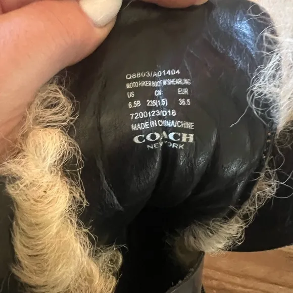 Coach woman’s black Moto Hiker boot with cream colored Shearling boots