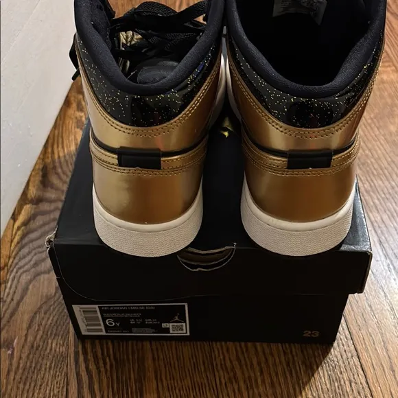 Worn 2x Air Jordan Black and Gold Sneakers size 6 kids.