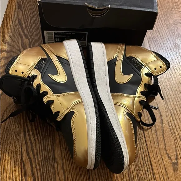 Worn 2x Air Jordan Black and Gold Sneakers size 6 kids.